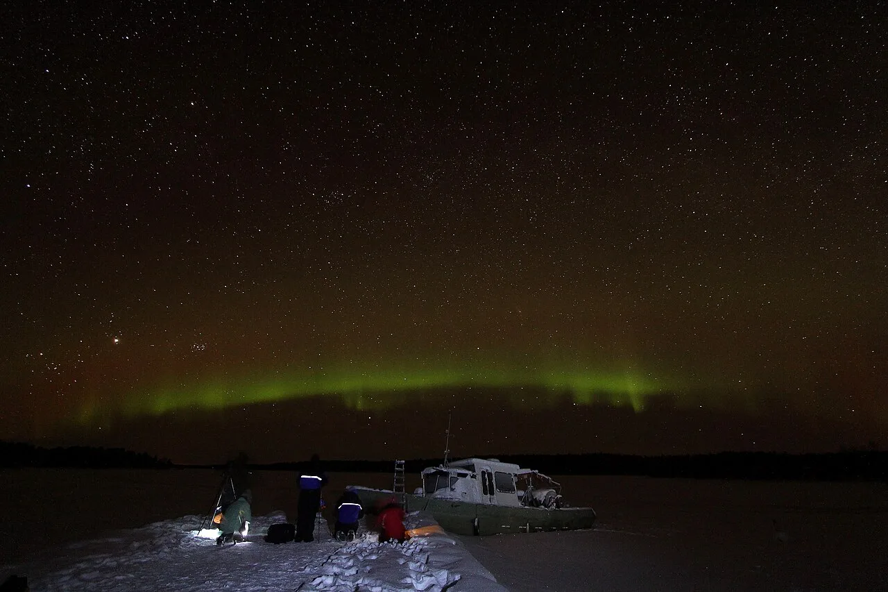 Aurora Borealis, stars, a ship, and photographers, Inari