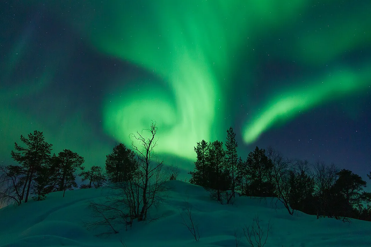 Northern lights band swirls above Vuopajanniemi, Inari, Lapland, Finland, March